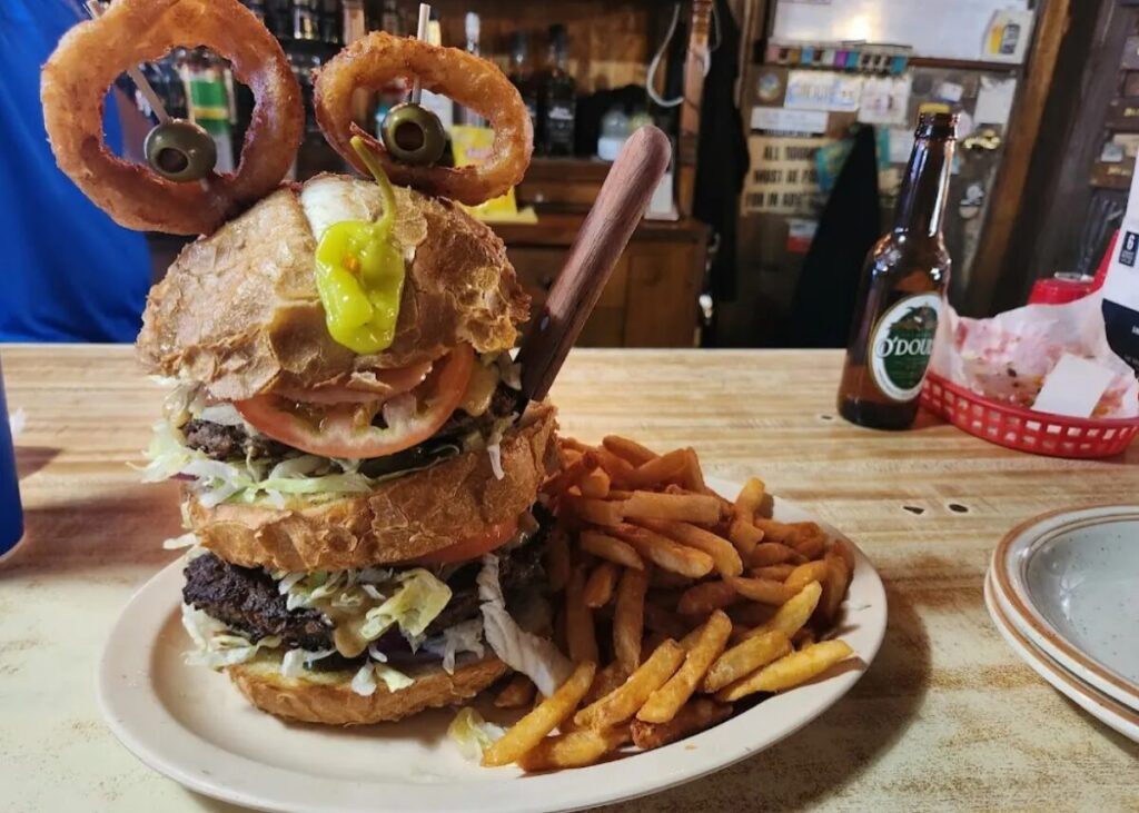 the Monster Burger, a towering creation with over a pound of beef and zesty hot peppers