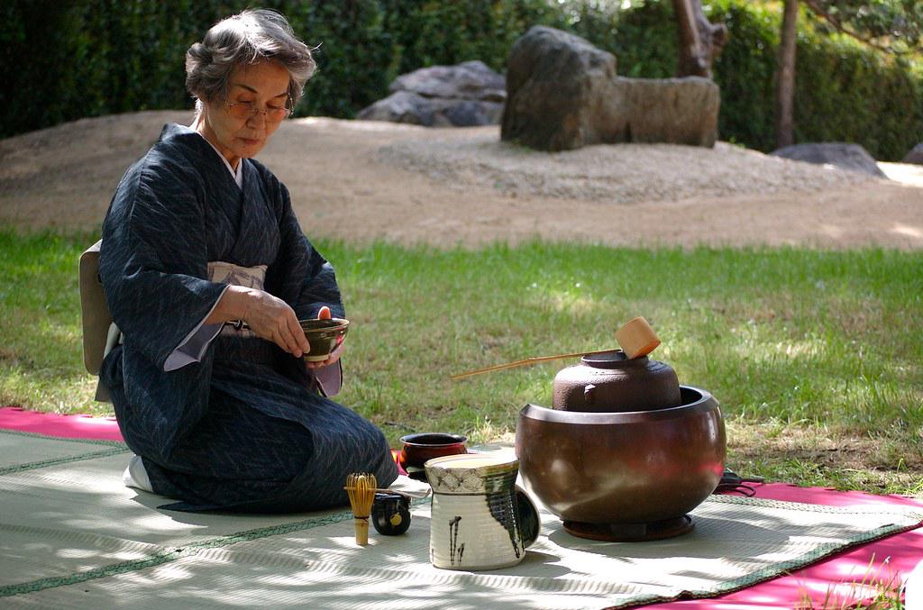 Solo traveler participating in a traditional Japanese tea ceremony